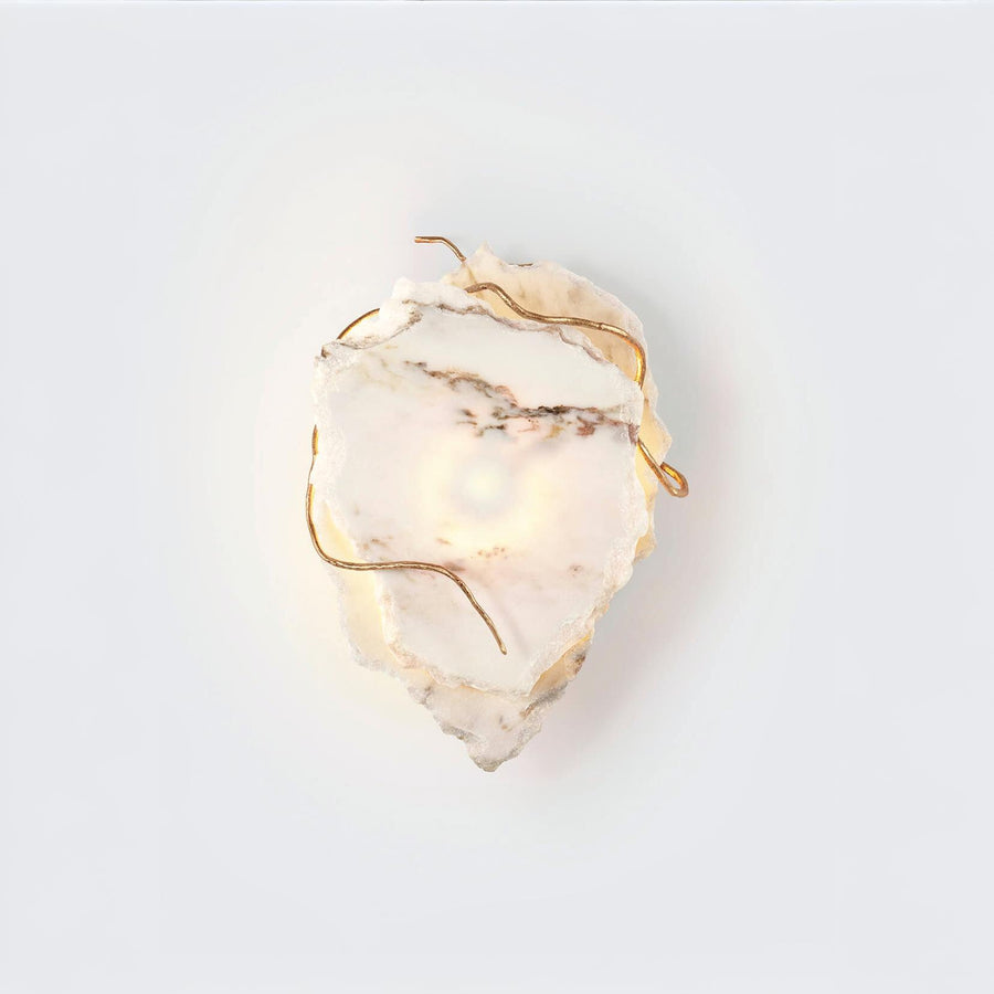 Marble wall sconce with gold accents on a white background