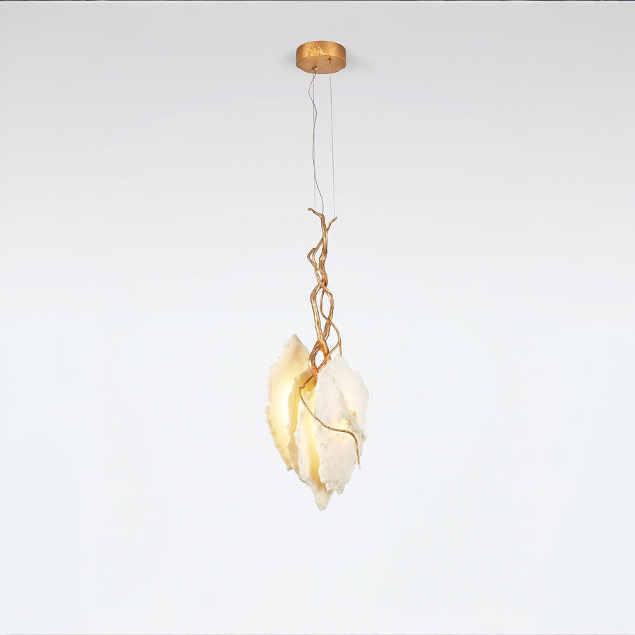 Modern pendant light with gold finish fixture and marble on a white background