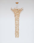 Gold chandelier hanging against a white background