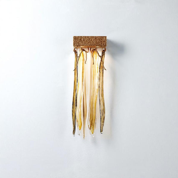 Decorative wall light fixture with gold finish on a white background