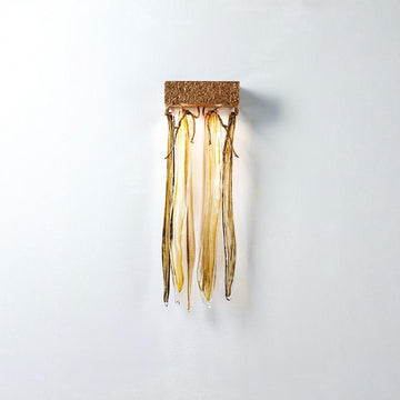 Decorative wall light fixture with gold finish on a white background