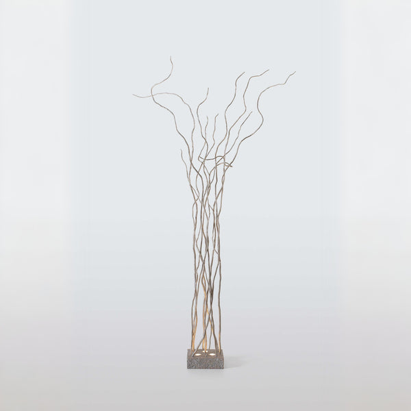 Decorative floor lamp of branches on a white background