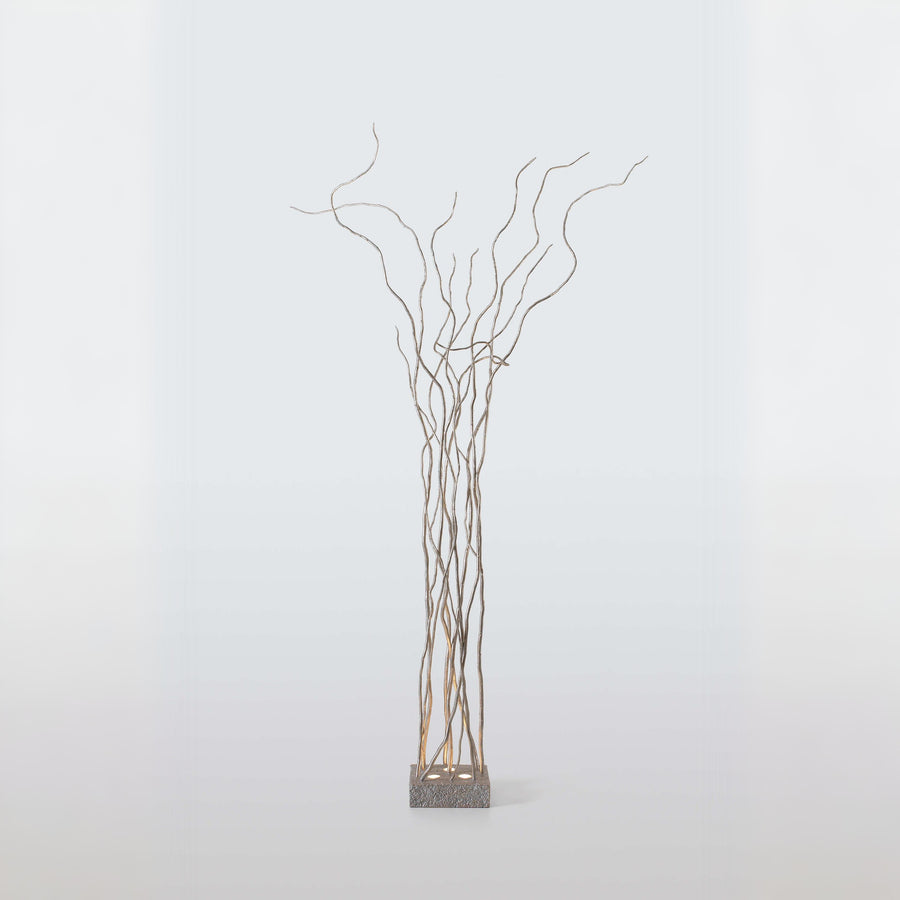 Decorative floor lamp of branches on a white background