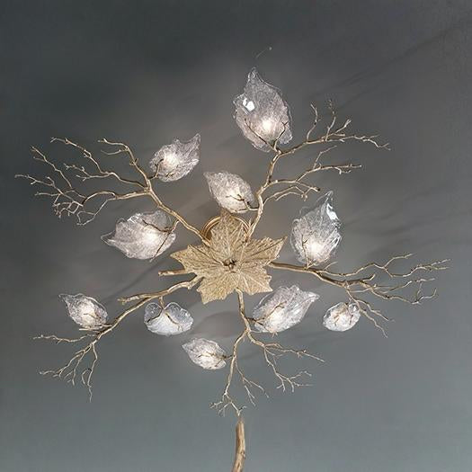 Ceiling light fixture with leaf and branch design on a dark background