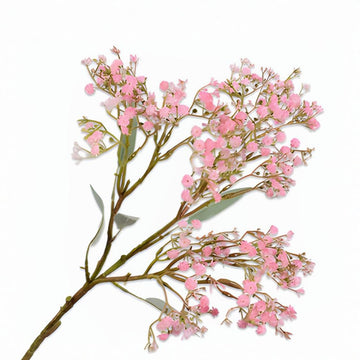 Artificial pink flower branch on a white background by Silk-Ka available at Spacio retail stores in Mumbai & Kolkata. 