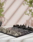 A architectural Indian monuments chess set with silver and black city-building pieces arranged on a black board, styled on a India map wooden board with potted plants and soft diagonal shadows in the background.