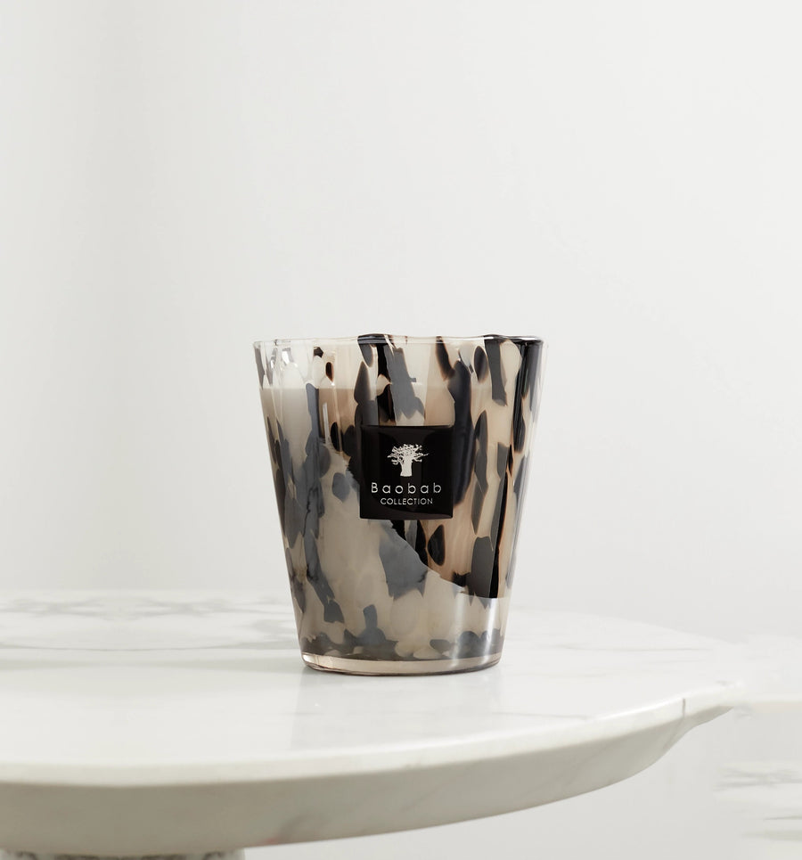 A Baobab Black Pearls Candle Max 16 MAX16PB, placed for decoration on a marble table.