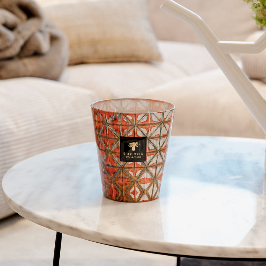 A Baobab Bohom Gyula Candle MAX16BGY fills the home with a floral fragrance as it sits on a table in a living room.