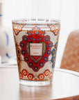 A Baobab Mexico Candle MAX16MEX scented candle is sitting on a table next to a lamp.