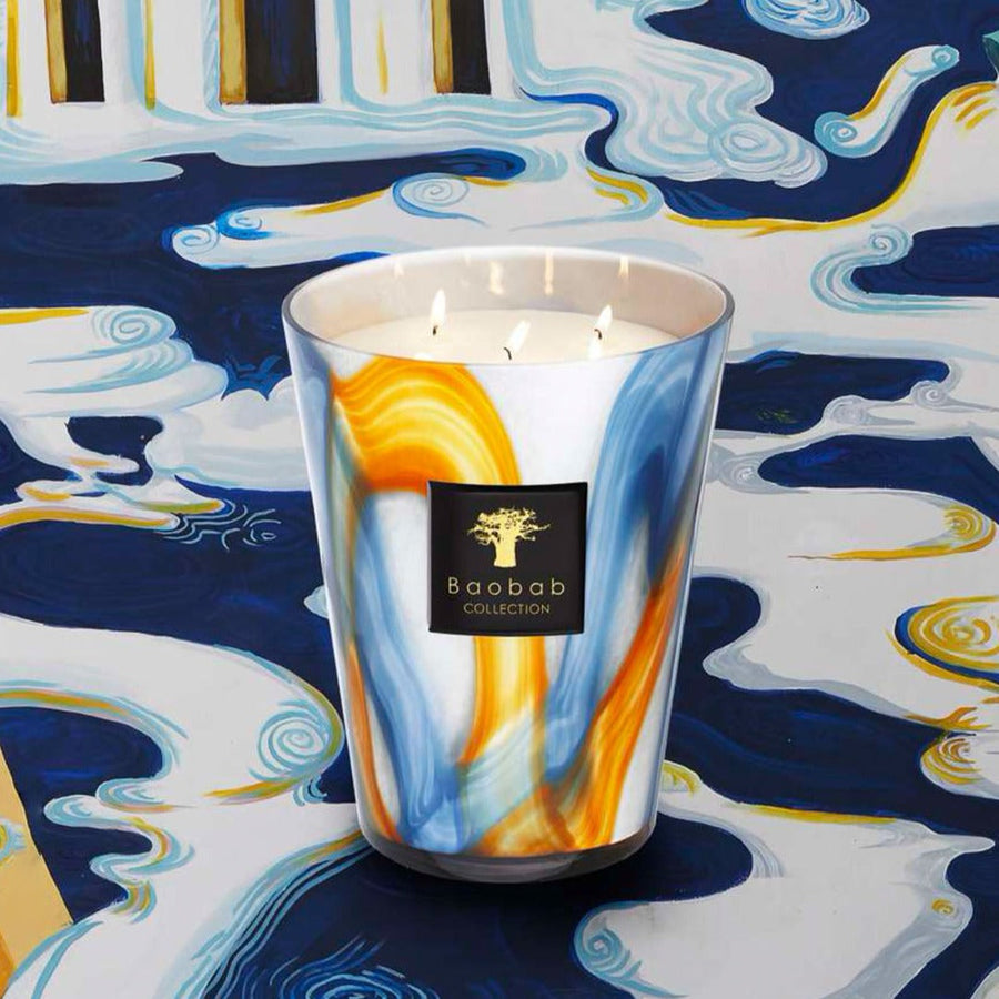 A Baobab Nirvana Holy Candle Max 16 MAX16NHO with a blue and yellow design on it, offering long burning hours.