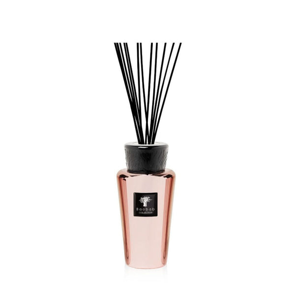 Baobab Roseum diffuser in a pink vase with black sticks, emitting a delightful fragrance.