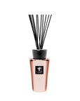 Baobab Roseum diffuser in a pink vase with black sticks, emitting a delightful fragrance.
