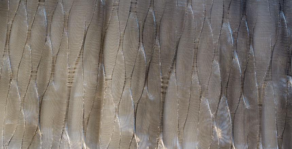 A close up of LCD Textiles' LCD Metal Fabric Ribbon Collection featuring light and silver hues.