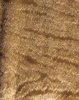 A close up of a brown leather surface featuring a delicate LCD Metal Fabric Moire Collection pattern by LCD Textiles.