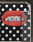 A luxury black and white polka dot wallpaper, reminiscent of a Londonart Toilet Paper Wash Your Mouth pattern, adorned with a lipstick silhouette.