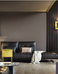 A living room with black and yellow furniture featuring the Masiero Ebe Wall Sconce from the Masiero brand collection of luxury lighting and decorative lights.