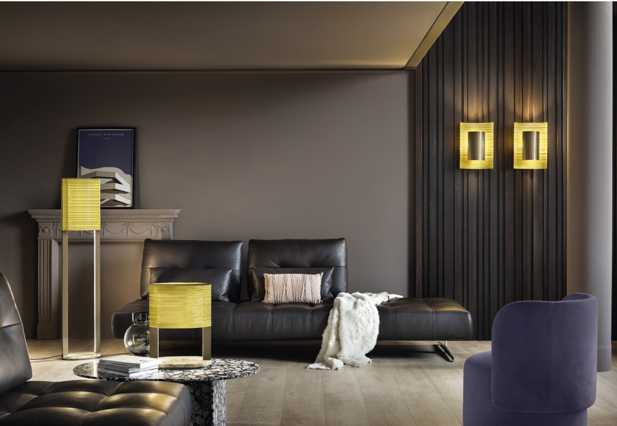 A living room with black and yellow furniture featuring Masiero Ebe Table Lamps, inspired by precious stones.