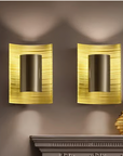 Two Masiero Ebe Wall Sconces from the Masiero Ebe Collection adorn a mantle.