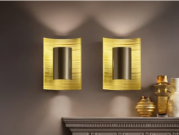 Two Masiero Ebe Wall Sconces from the Masiero Ebe Collection adorn a mantle.