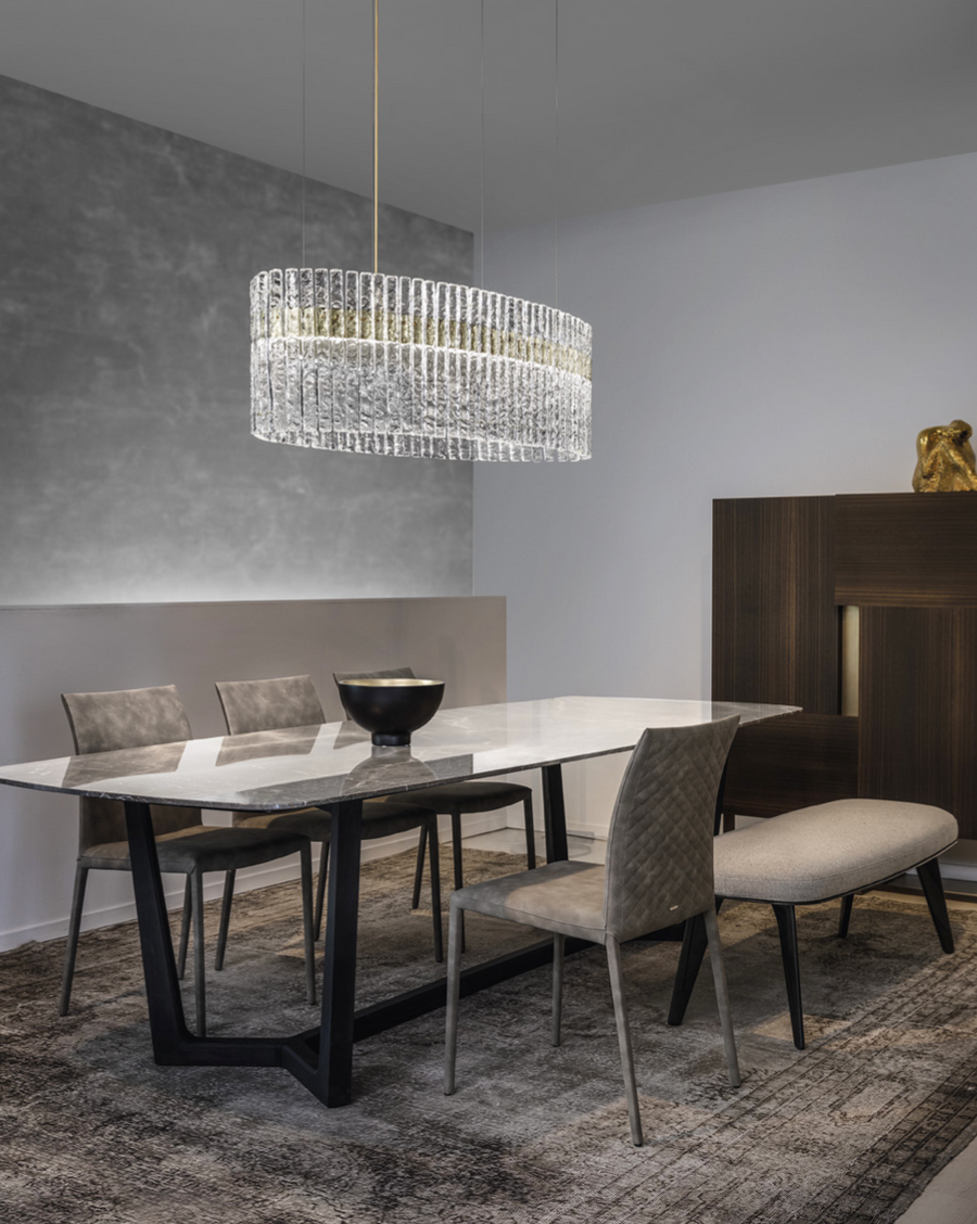 A modern dining room with Masiero Vegas Chandelier lights and chairs.