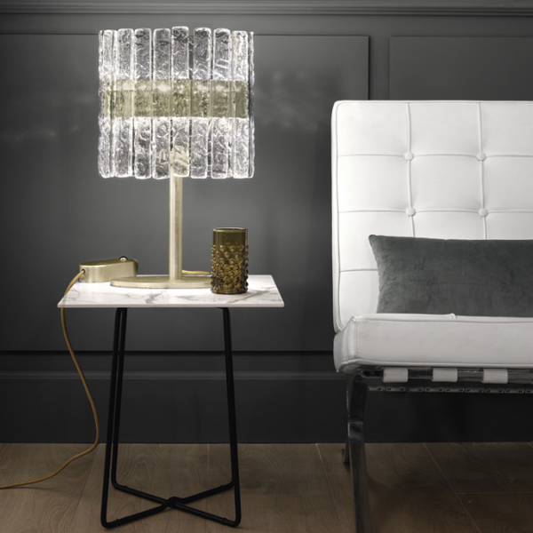 A white couch and a Masiero Vegas Table Lamp in a room with black walls.