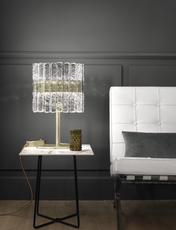 A white couch and a Masiero Vegas Table Lamp in a room with black walls.