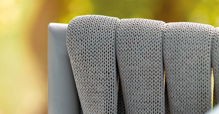 A close up of a Sifas Basket Sofa Collection chair with waterproof properties.