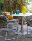 A Sifas waterproof outdoor furniture set consisting of a table and chairs, perfect for the garden.