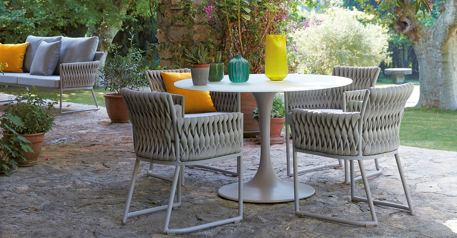 A Sifas waterproof outdoor furniture set consisting of a table and chairs, perfect for the garden.