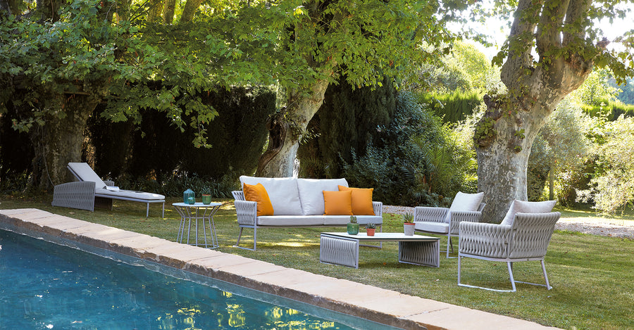 The Sifas Basket Sofa Collection, a outdoor furniture collection featuring waterproof properties, is perfect for lounging near a swimming pool.