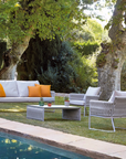 The Sifas Basket Sofa Collection, a outdoor furniture collection featuring waterproof properties, is perfect for lounging near a swimming pool.