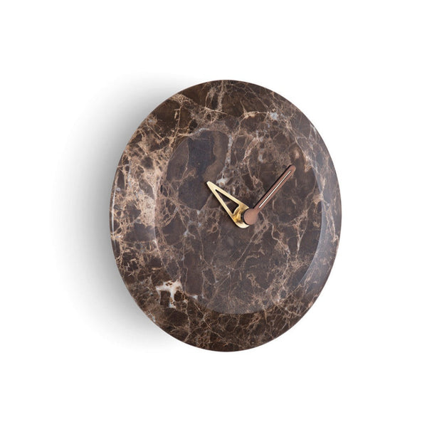 A Nomon Bari S Emperador HUGSE levitating marble clock on a white wall.