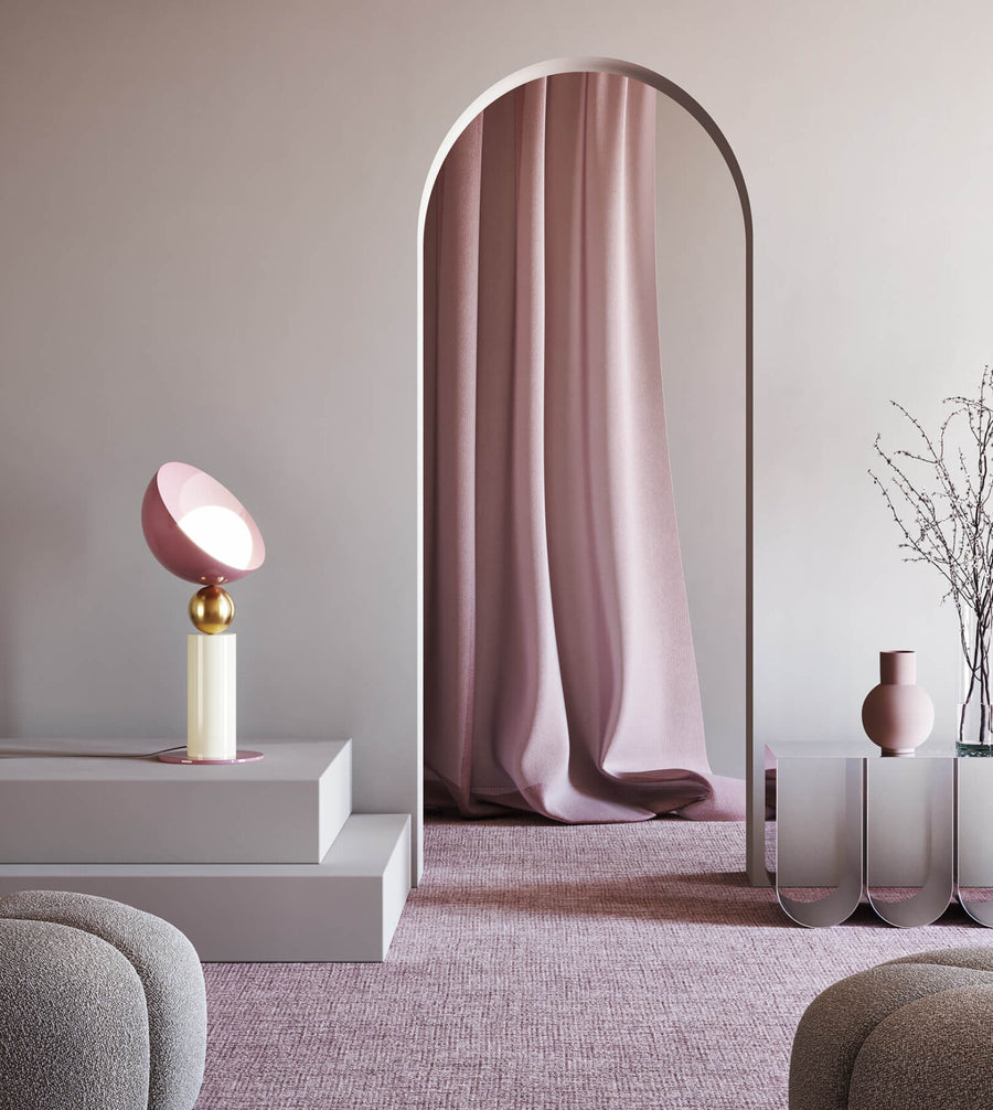 A versatile and vibrant lighting design from the Aurora Collection by Italamp featuring brushed gold accents, white glass diffuser, and retro-inspired finishes. A pink and ivory finish table lamp styled on steps in a pink theme design set by interior stylist navin kanodia of spacio mumbai