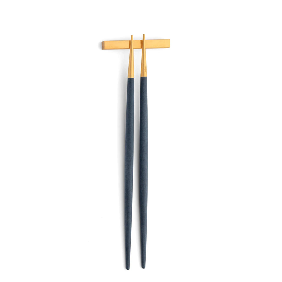 Cutipol Goa blue matt gold finish, black resin handles, and minimalist design for a luxurious dining experience - on a white background  chopsticks with pillow