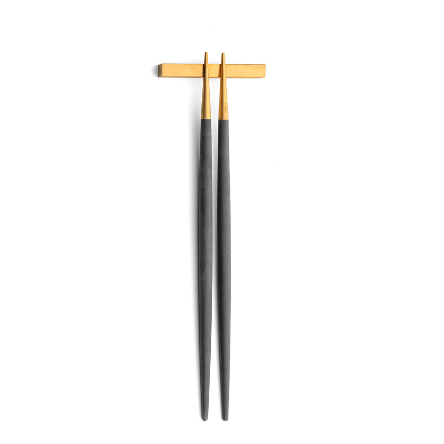 Cutipol Goa grey matt celadon finish, black resin handles, and minimalist design for a luxurious dining experience - on a white background  chopsticks on pillow