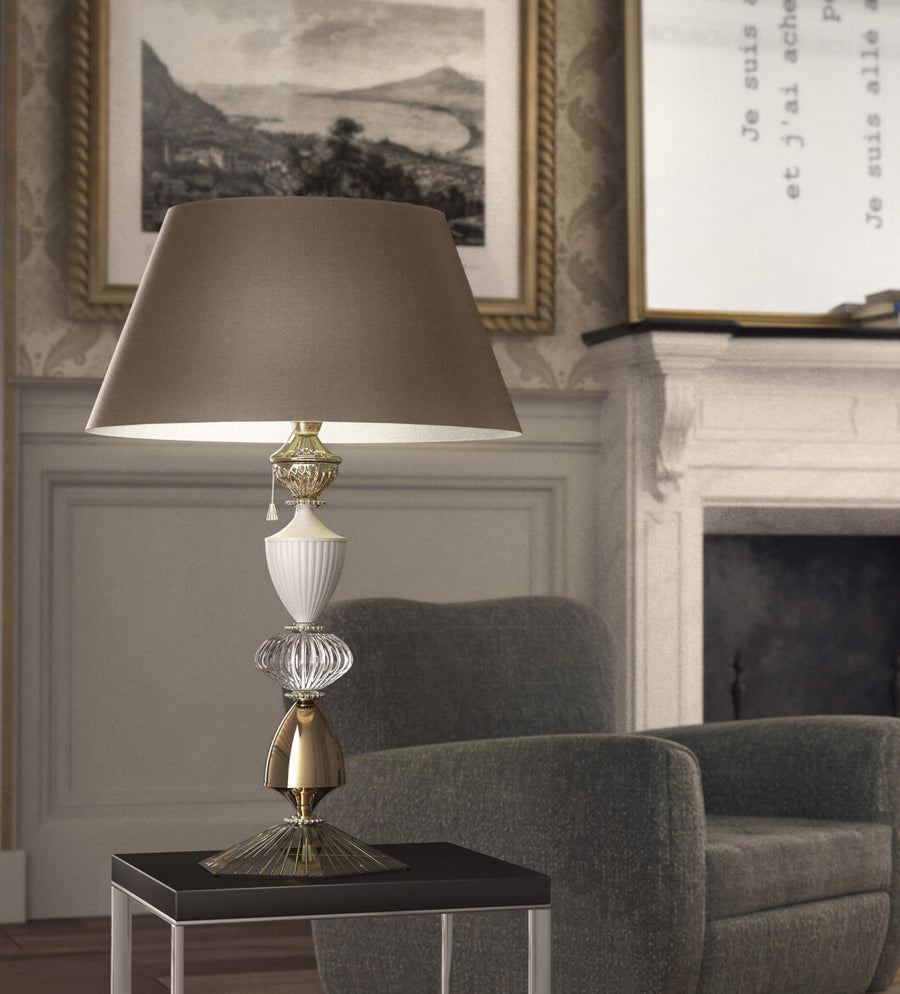 Amelie table lamp by Italamp featuring crystal and white/nickel metal, blending classic elegance with modern design. Perfect for luxury interiors. Styled on a side table of a luxury living room corner