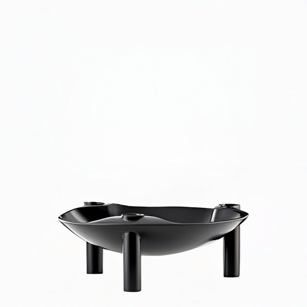 A black metal candle holder with a wide, shallow bowl shape and three short cylindrical legs, shown on a plain white background.