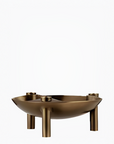 A modern bronze metal bowl with three cylindrical legs and small side supports, shown on a plain white background.