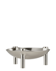 A modern chrome finish bowl with three cylindrical legs as candle holder, photographed on a seamless white background.
