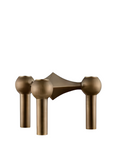 A modern three hole candle holder with a bronze finish, featuring three spherical shades on vertical cylindrical stems with a geometric central bar, shown against a plain white background. From Stoff Nagel Denmark, available at Spacio in India. 
