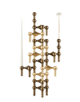 A modern multi-arm metal wall sconce or candle holder in a warm brushed brass/gold finish, shown with two white taper candles on a plain white background.