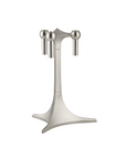 A modern three-light candlestick holder with a brushed silver metal finish, featuring a central stem with three spherical finials at the top and a wide, sculptural base.
