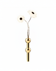 A minimalist brass metal vase with a vertical cylindrical body and two rounded decorative nodes, holding two artificial white daisy flowers with dark centers, set against a solid white background.