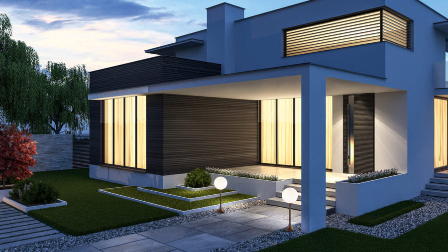 Modern house exterior with floor lamps from Masiero & lit up windows at dusk