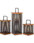 Set of three decorative solar lanterns with wooden tops and black metal bodies on a white background