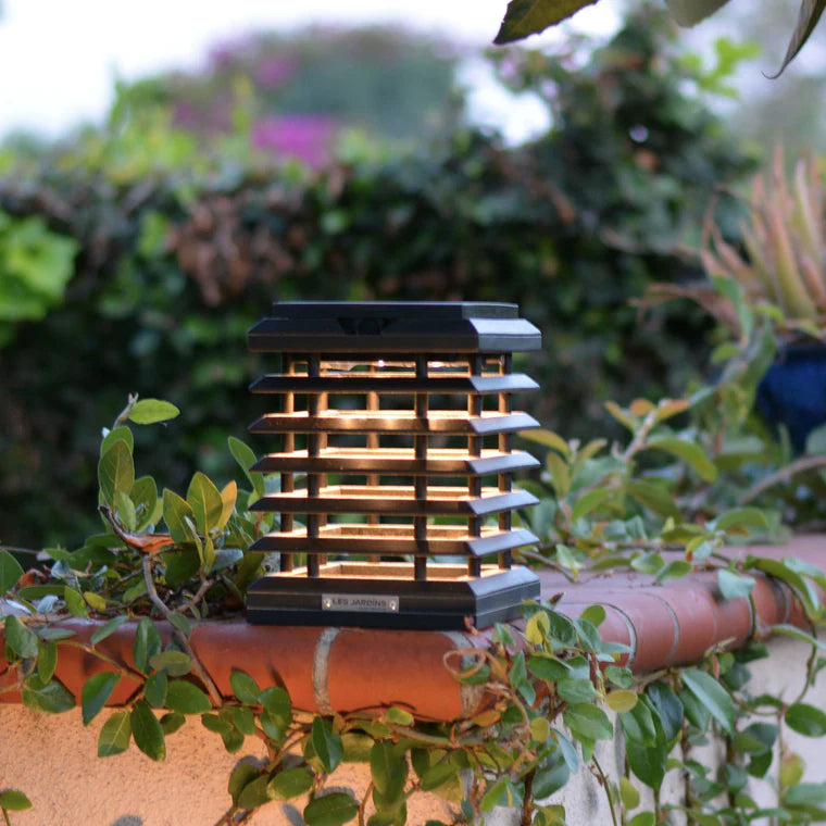 Solar lamp on a pot with greenery in the background by Les Jardins available at Spacio retail stores in Mumbai & Kolkata. 