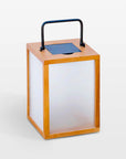 Solar lantern with wooden frame and blue solar panel on a white background