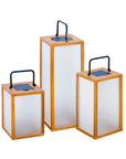 Three rectangular solar lanterns with wooden frames and white panels on a white background