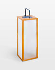 Tall rectangular solar lamp with wooden frame and white glass on a white background