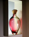 Sculptural Vase on a light shelf against a dark background